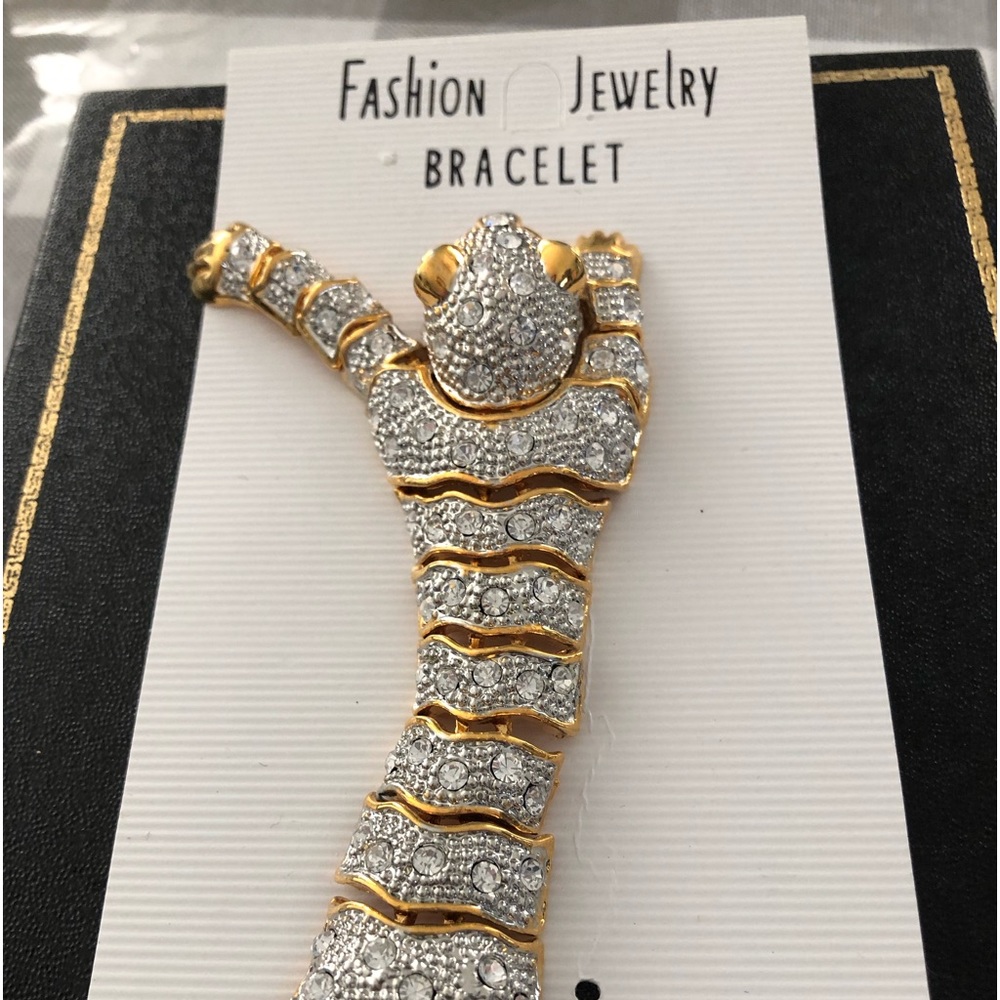 Goldtone tiger bracelet. 7 1/2 inches long.Has a little weight to it.